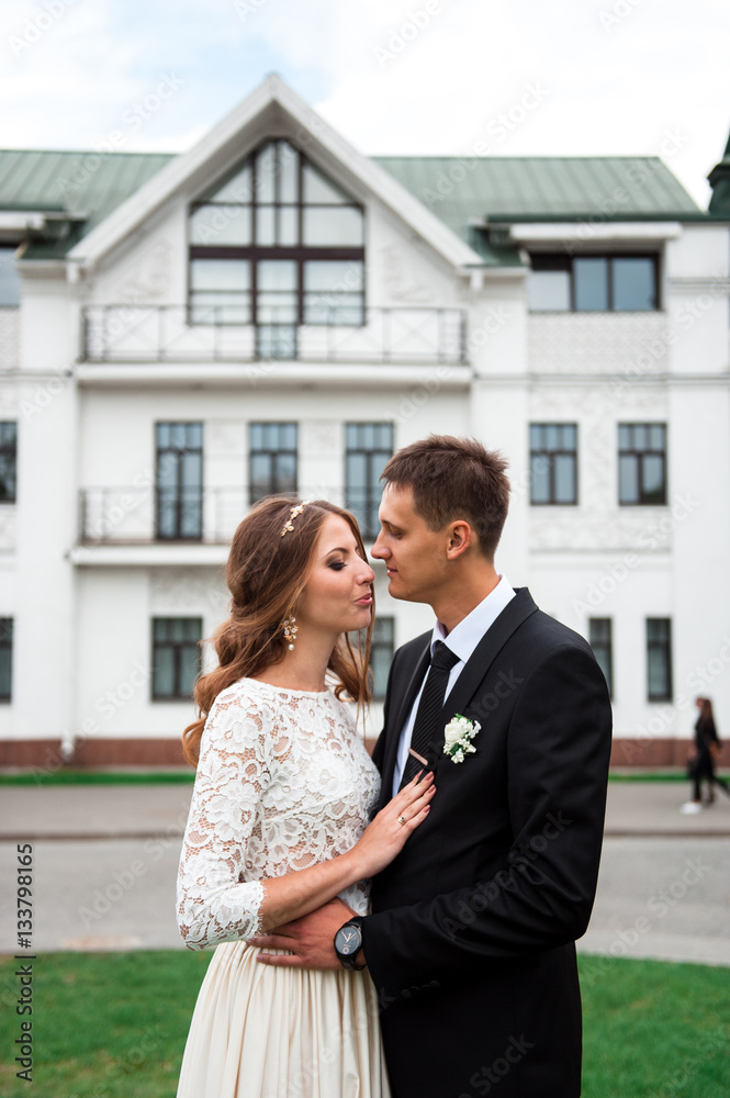 gorgeous happy wedding couple walking and kissing in the old city of Minsk, Belarus