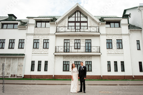 gorgeous happy wedding couple walking and kissing in the old city of Minsk, Belarus © dashamuller