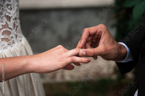 The groom puts on a ring a hand to the bride