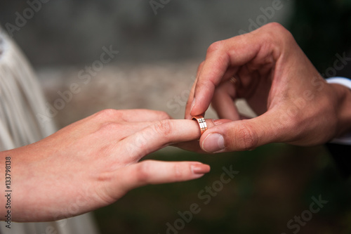 The groom puts on a ring a hand to the bride © dashamuller