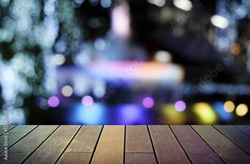 image of wooden table in front of abstract blurred background