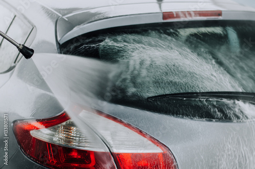 Cleaning Car Using High Pressure Water. photo