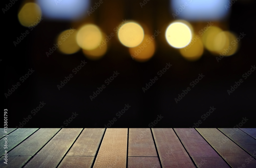image of wooden table in front of abstract blurred background