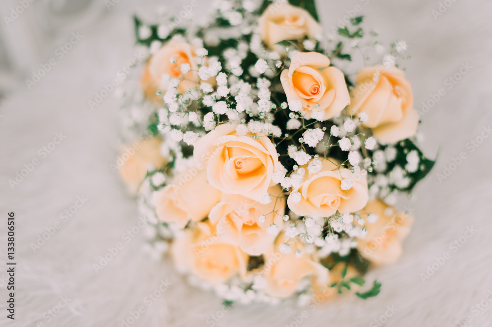 Bouquet of yellow roses and wedding rings