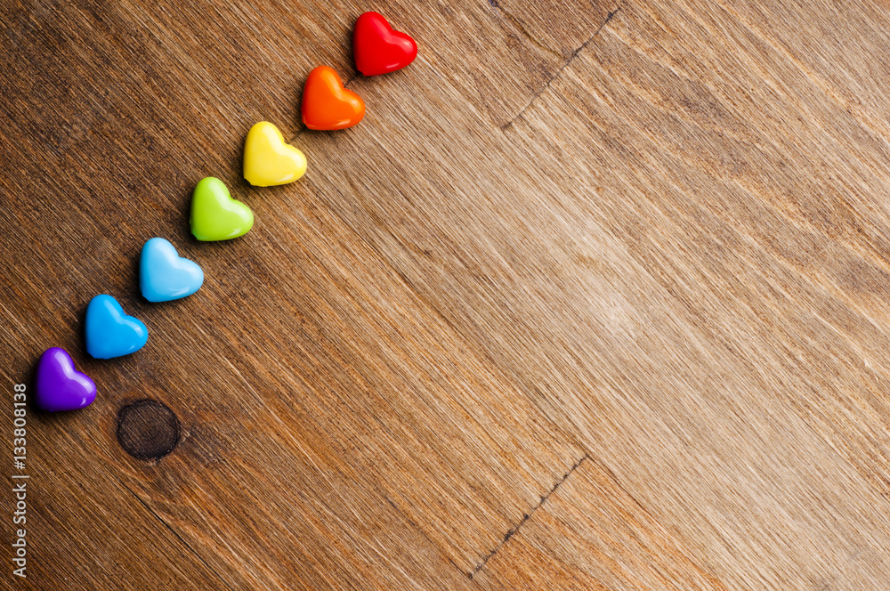 Bright hearts on wooden background Bright hearts on wooden background