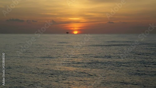 gulf of mexico oil rig gas platform and sunset wide shot
