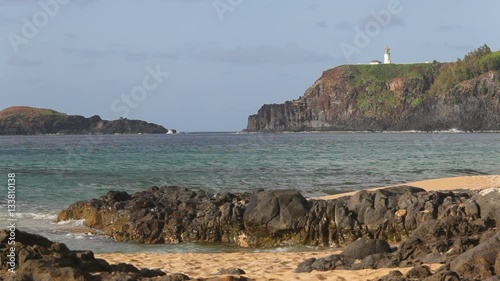 Kilauea Lighthouse and Mokuaeae Island as seen from Secret Beach (Kauapea Beach) on Kauai's northern shore. photo