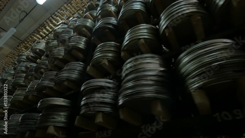 Film Archive. Films, movie reels on a shelfs in a huge old movie archive. 4K. photo