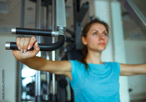 Woman works out on training apparatus in fitness center