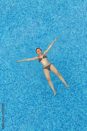 Young woman relaxing in the pool © vladstar