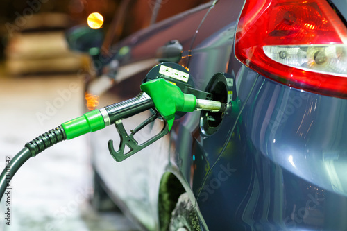 Car refueling on a petrol station in winter at night