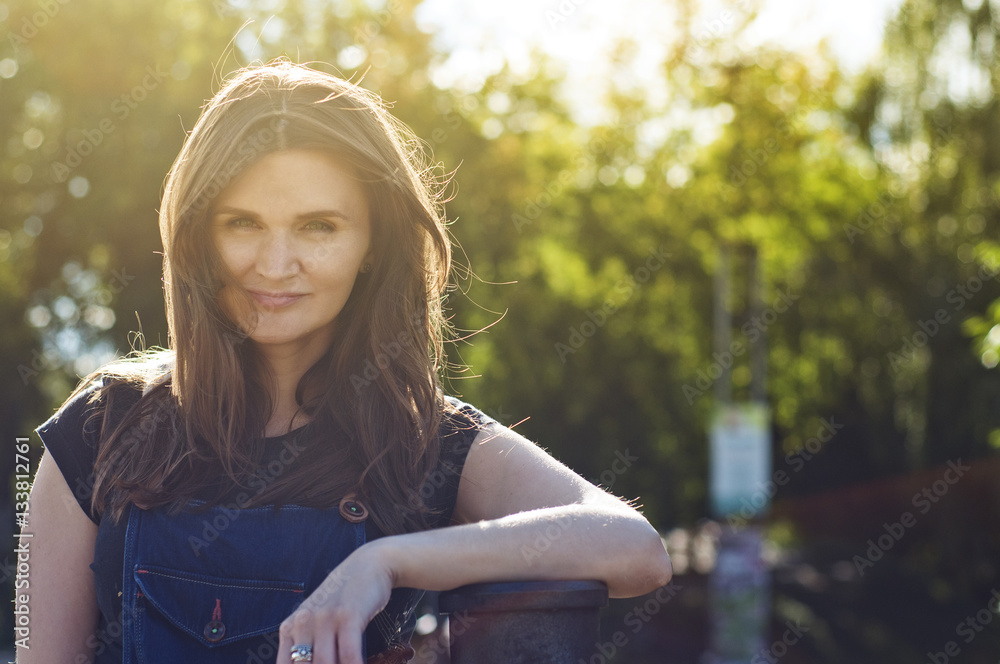 Naklejka premium beautiful girl in a summer park in the sun
