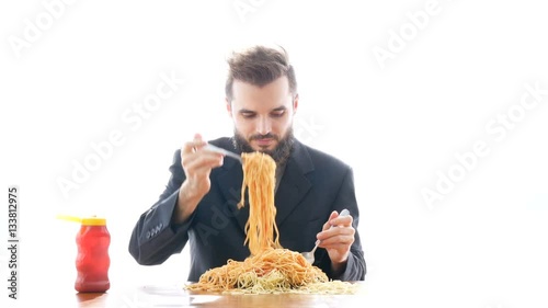 Funny businessman eating pasta on the table. Overeating and greedy consumerism concept, studio isolated on white background.