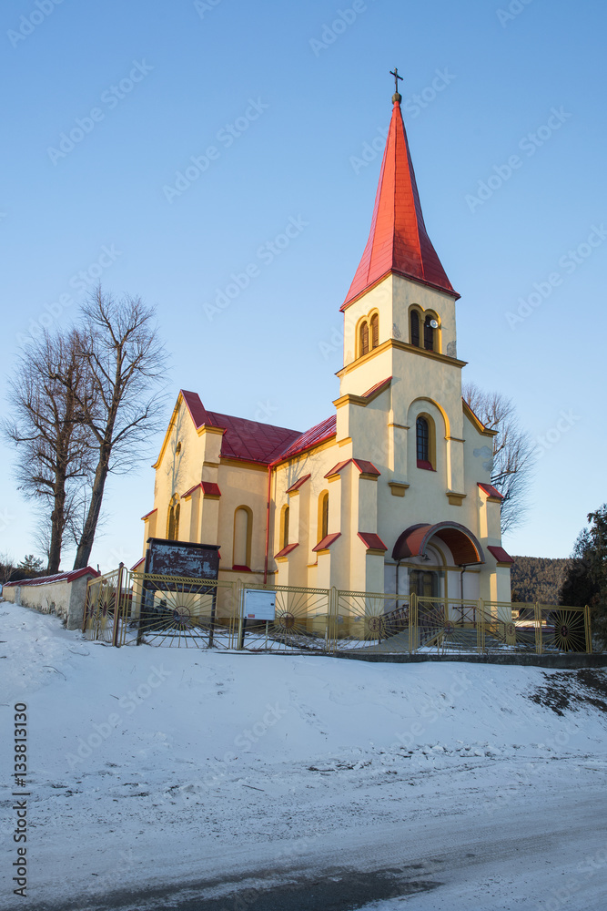 wide angle view to the church with red roof