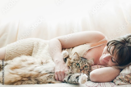 Fototapeta Naklejka Na Ścianę i Meble -  Beautiful pregnant girl sleeping on a bed with a beautiful large