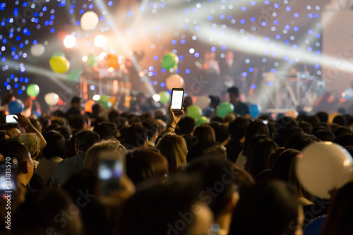 Cheering crowd in new year party, holiday celebration background