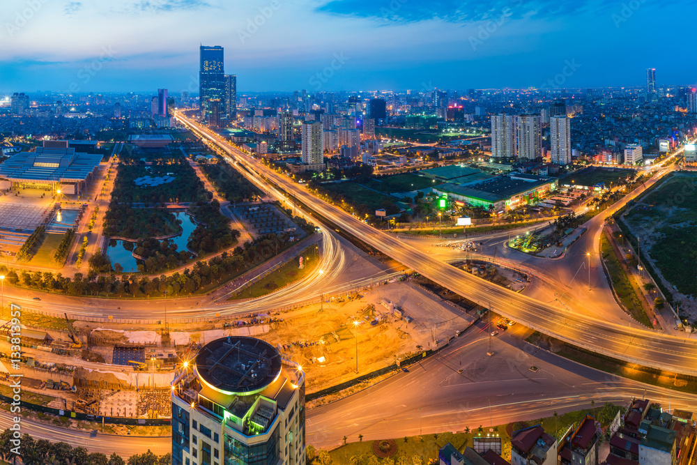 Naklejka premium Aerial skyline view of Hanoi cityscape at twilight. Thang Long freeway and Pham Hung street
