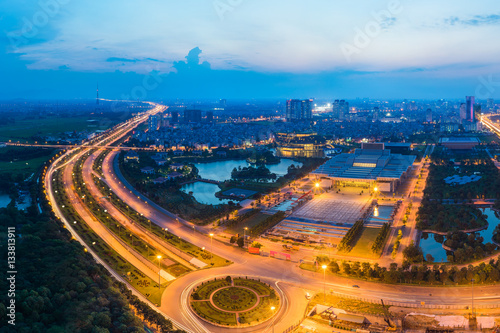 Aerial skyline view of Hanoi cityscape at twilight. Thang Long freeway and Pham Hung street