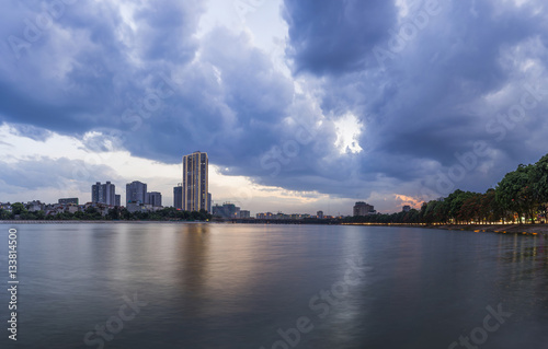 Linh Dam lake at sunset with cloudy sky. Hanoi cityscape