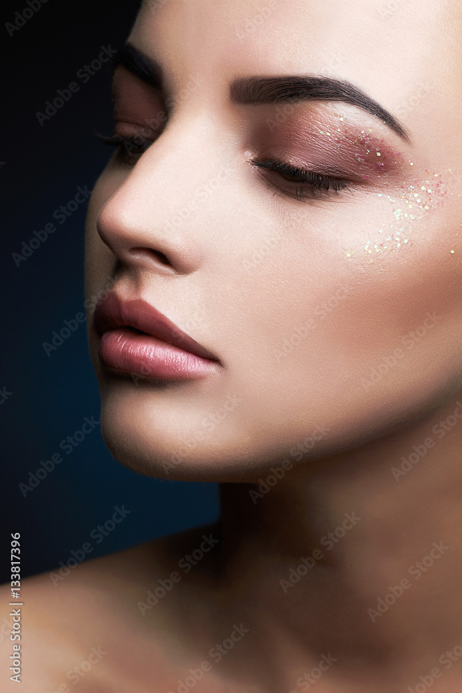 Beauty Makeup with glitter eye shadows.Beautiful Woman Makeup. female face Beauty Makeup with glitter eye shadows.Beautiful Woman Makeup. female face