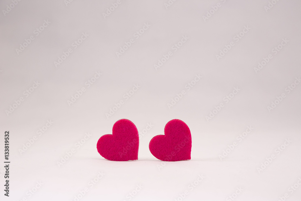 Fototapeta premium two red felt hearts on white