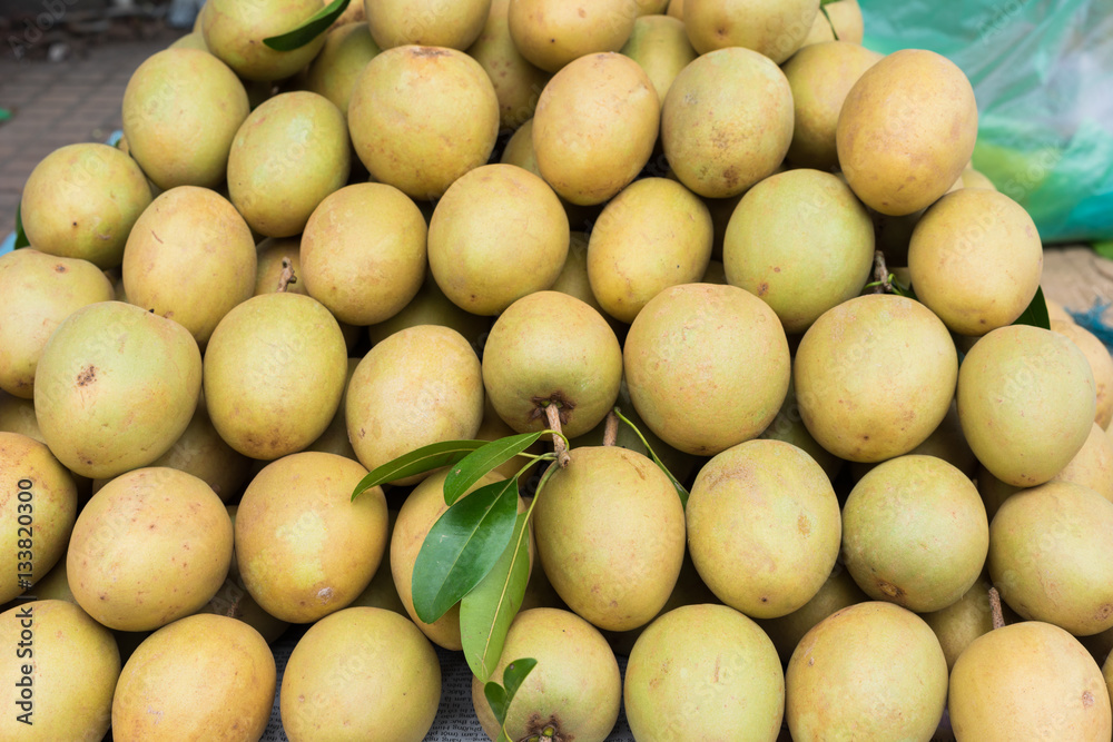 Sapodilla, tropical fruit displayed at Vinh Long fruit market, Mekong delta. The majority of Vietnam's fruits come from the many orchards of the Mekong Delta