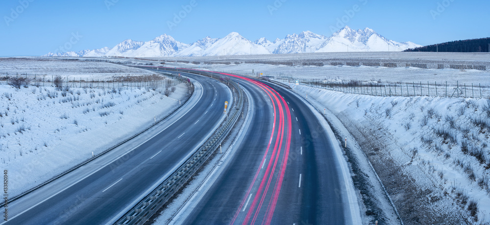 panorama with mountains and highway with traffic