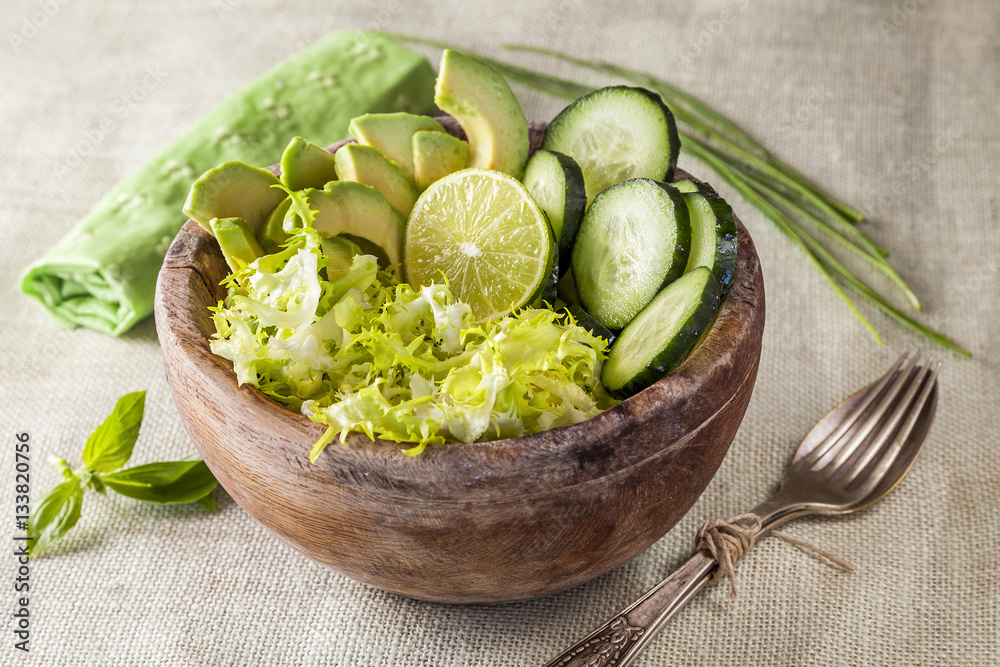 Bowl of green salad of cucumber, escarole and avocado, delicious Bowl of green salad of cucumber, escarole and avocado, delicious