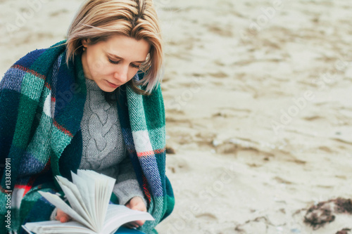 Wallpaper Mural A girl reads a book on the beach
 Torontodigital.ca