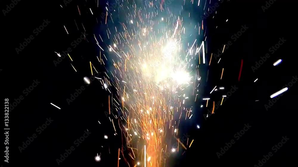 Close up of fireworks display beautifuls sparks and colors bursting out of pyrotechnic setup colored explosions and different light smoke noise effects fireworks festival often used at celebrations