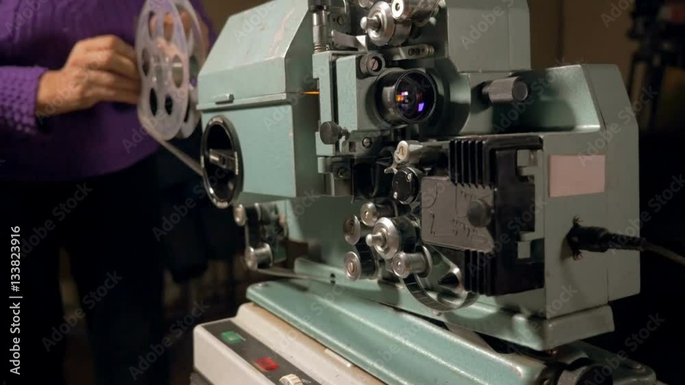 worker switch on antique Film Projector. HD. worker switch on antique Film Projector. HD.