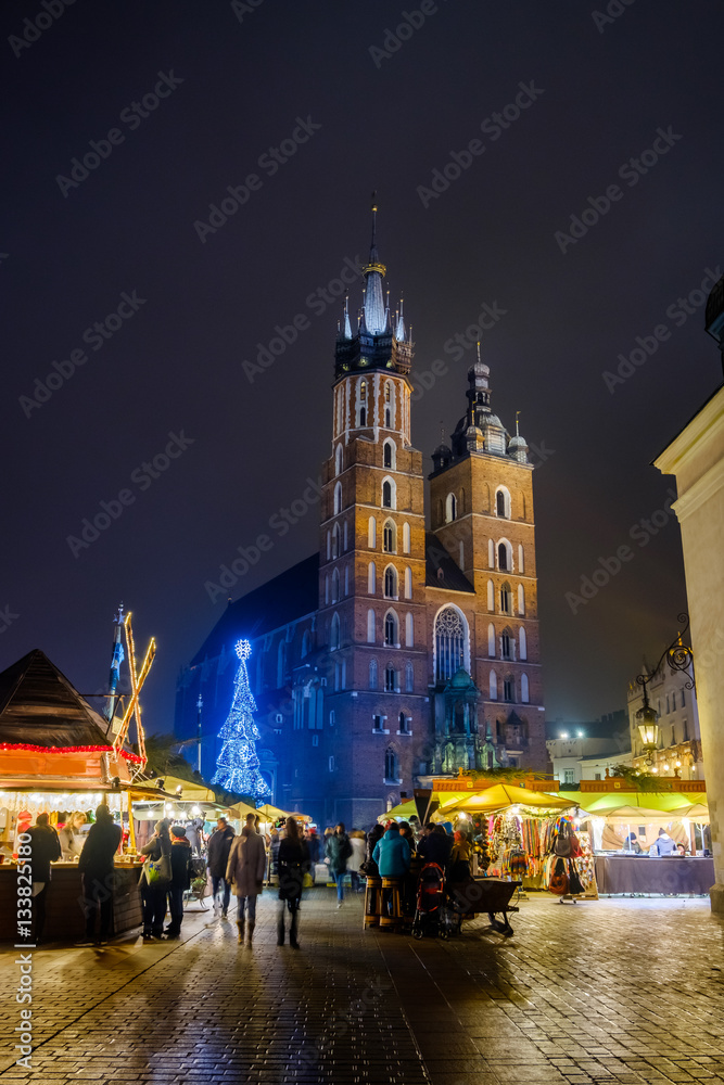 People visit Christmas market at main square in old city of Krakow, Poland