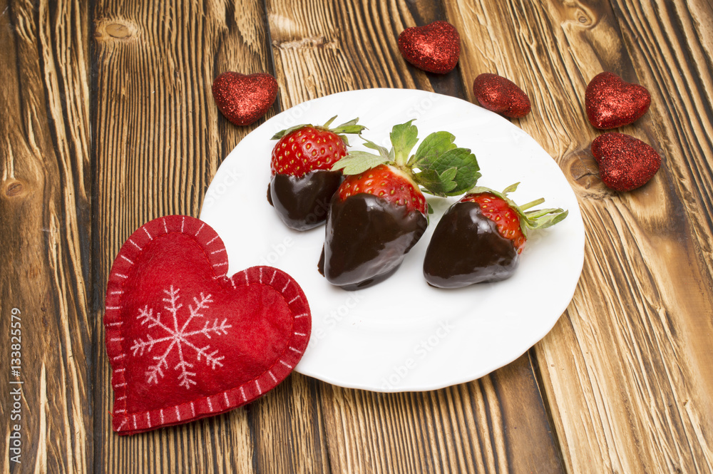Fresh strawberries dipped in dark chocolate and heart on wooden background. Valentine's Day