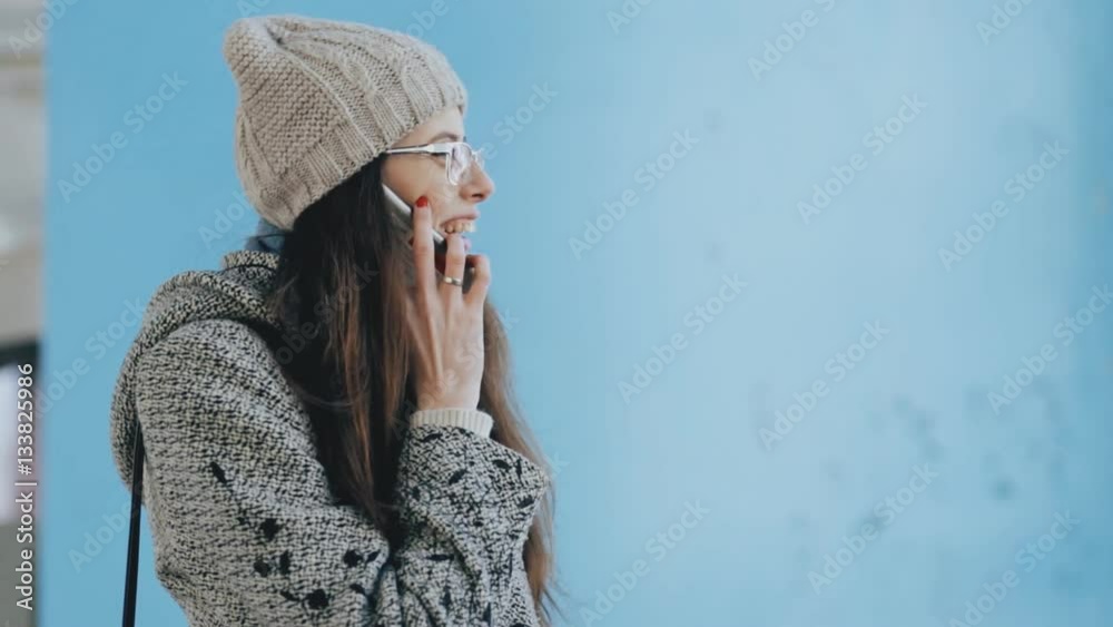 Woman talking on phone in old public abandoned building Woman talking on phone in old public abandoned building