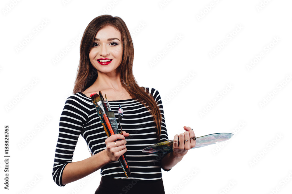 Cute beautiful girl artist holding a palette and brush in the process draws inspiration. White background, isolated. Cute beautiful girl artist holding a palette and brush in the process draws inspiration. White background, isolated.