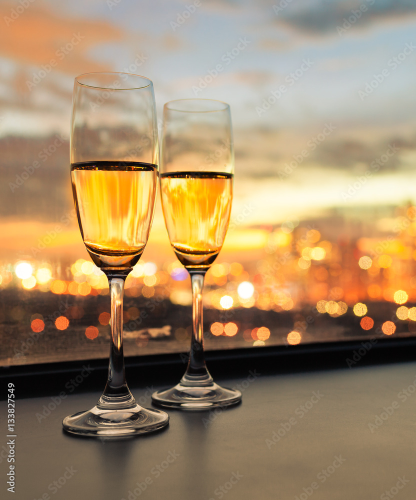 Pair of champaign alcoholic drinks in a luxury city setting.  