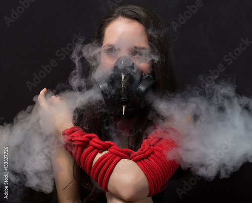 cyber goth girl with gas mask isolated on a dark background