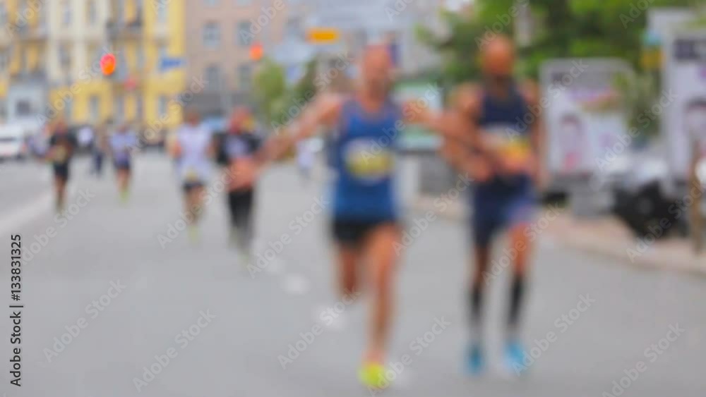 Blurred shot of people running on marathon on street Blurred shot of people running on marathon on street