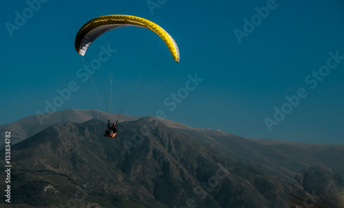  paragliding on a background of mountains and sky