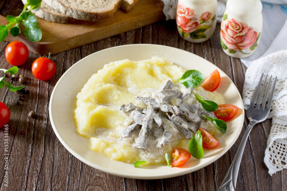 Traditional hot meat stew with sour cream and garnish mashed pot Traditional hot meat stew with sour cream and garnish mashed pot