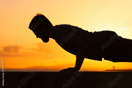 Fototapeta Naklejka Na Ścianę i Meble -  Silhouette of man dong push up exercise.
