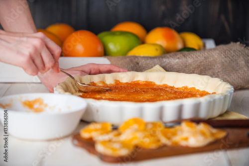 production of cake with citrus marmalade and slices of mandarin