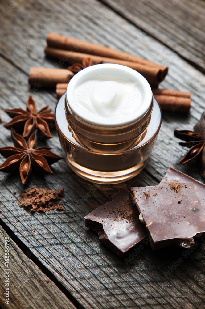 Chocolate skin treatment. Cosmetic jar with lotion, cocoa, anise, cinnamon sticks. Chocolate skin treatment. Cosmetic jar with lotion, cocoa, anise, cinnamon sticks.