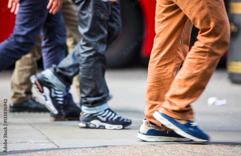 Feet of pedestrians walking on the crosswalk in Oxford street, London. Modern life, travel and shopping concept Feet of pedestrians walking on the crosswalk in Oxford street, London. Modern life, travel and shopping concept