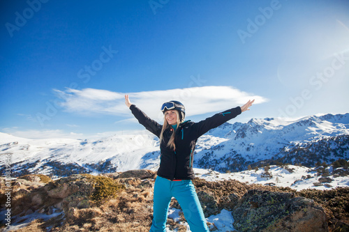 woman in the mountains winter holidays dress in a ski suite