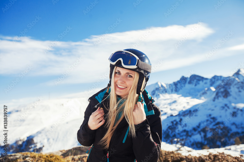 woman in the mountains winter holidays dress in a ski suite