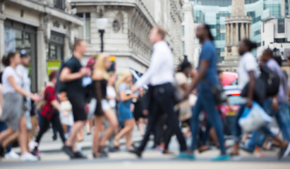 Regent street with lots of walking people crossing the road. Blurred image for background