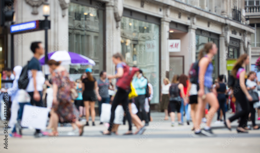 Regent street with lots of walking people crossing the road. Blurred image for background