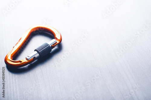 Carbine on a light table. Climbing. Equipment for mountaineering and climbing.  photo