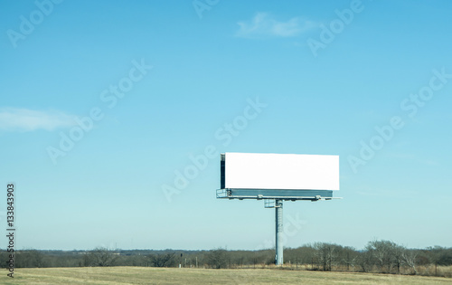 a blank billboard on highway with clear bluesky background